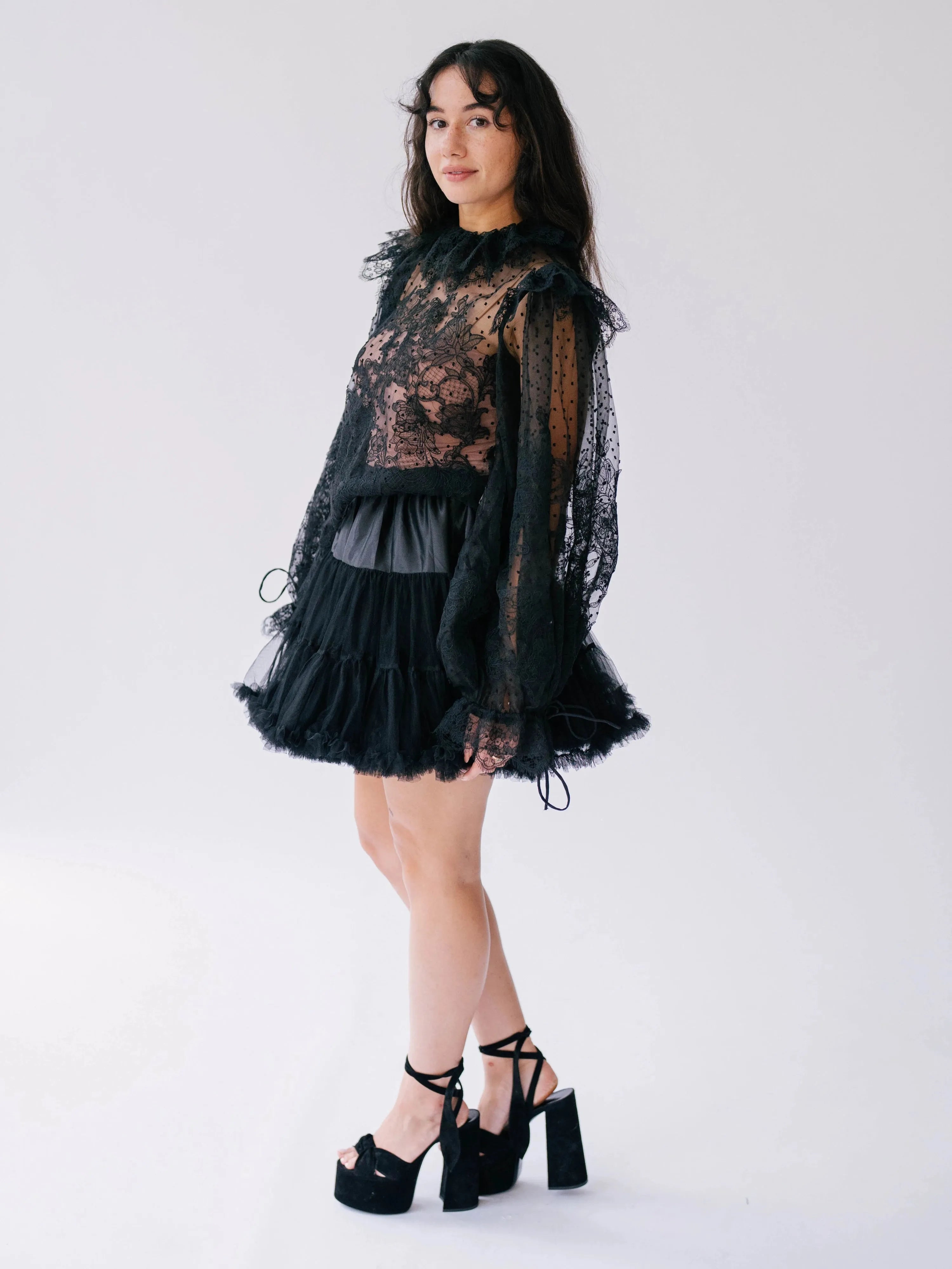 Side view of The Eleanor Midnight Black Lace Top showcasing romantic puff sleeves and delicate lace detailing for a gothic fairytale look.