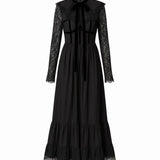 Black cotton dress called the Eveline dress, with lace details on a white background.