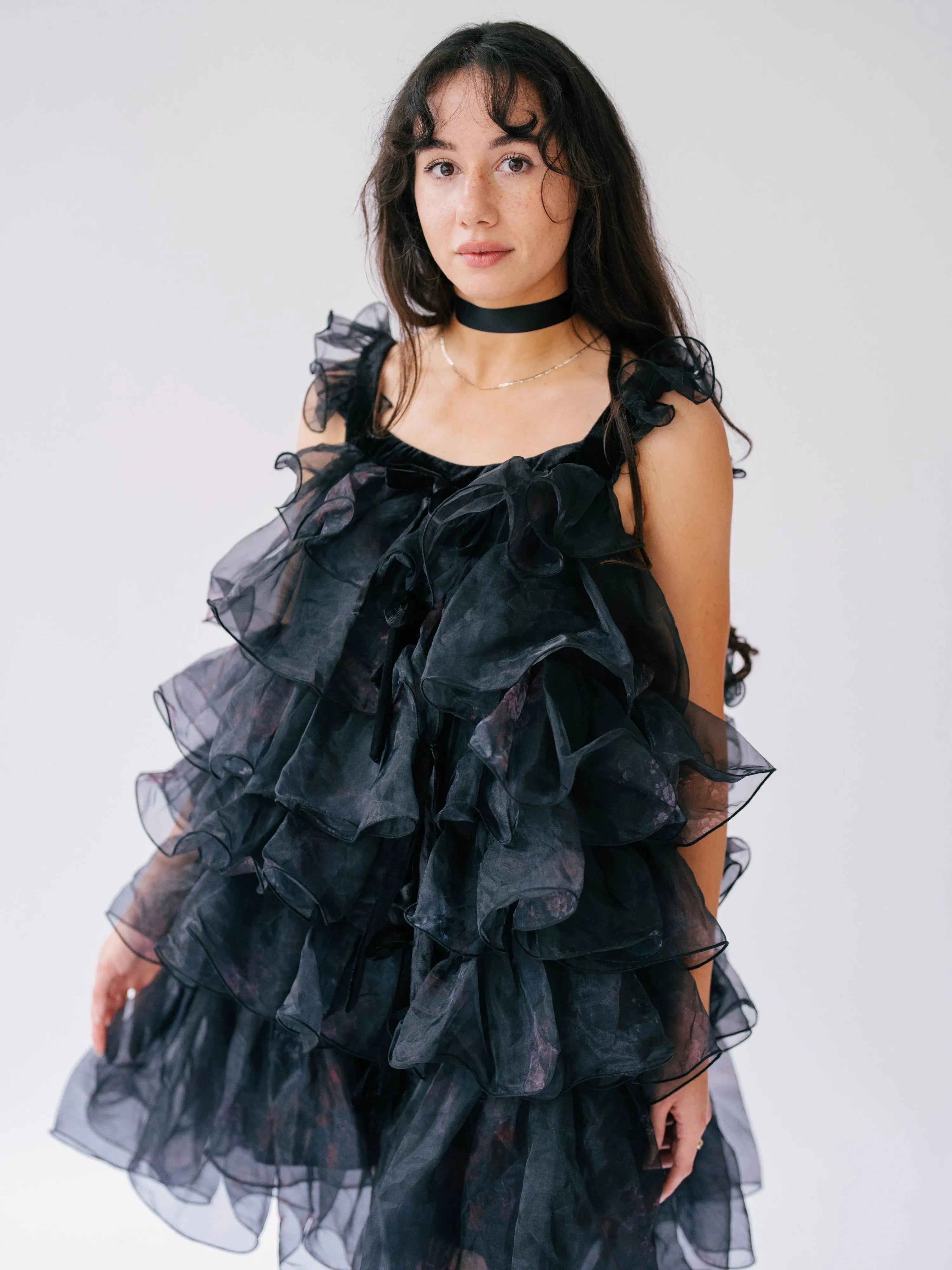 Front view of a woman wearing the light as a feather puff dress, showcasing the ghostly floral print.