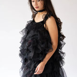 A side view of a woman wearing the light as a feather puff dress.
