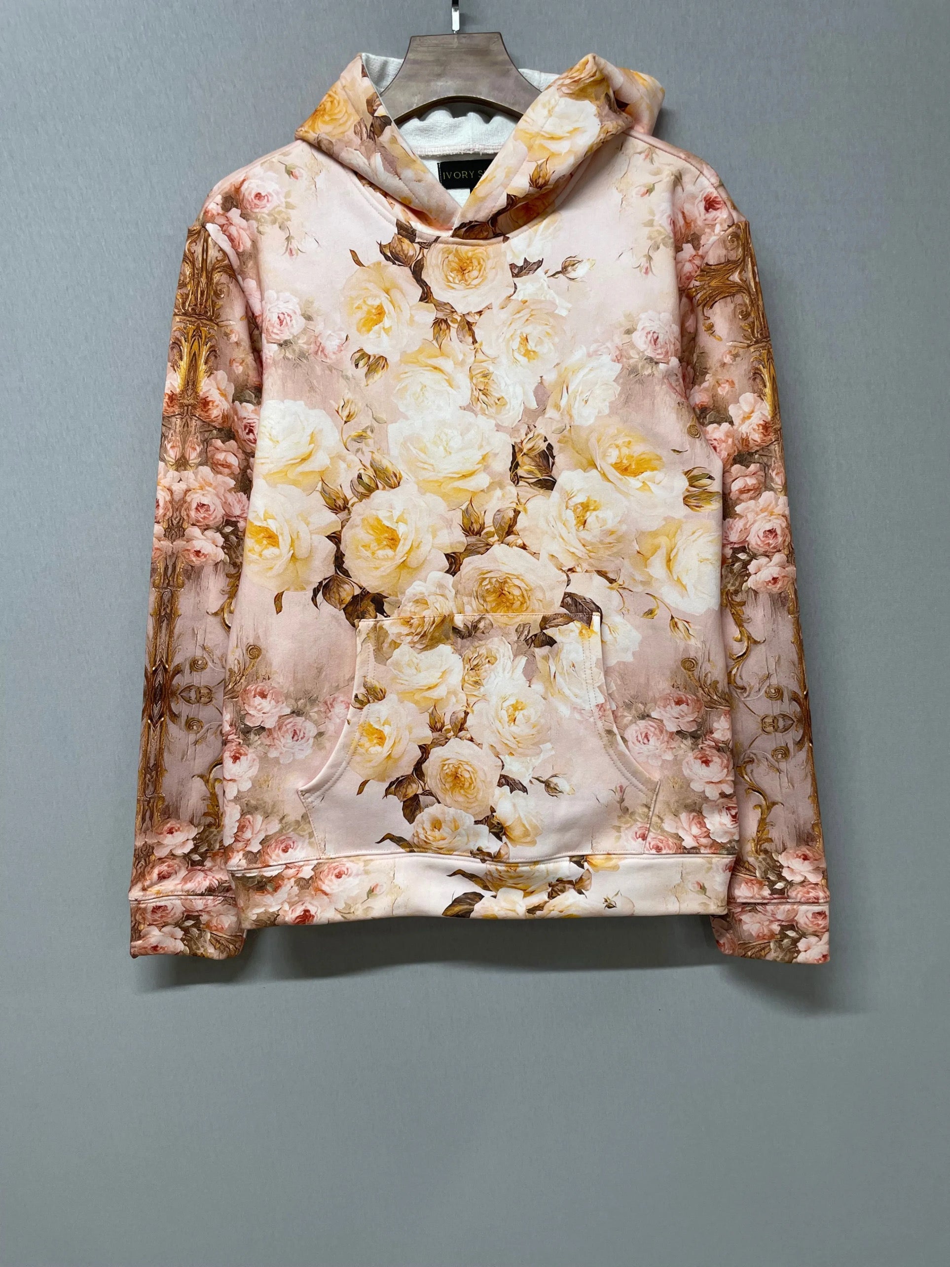 Flat lay of The Twilight Bloom Pullover Hoodie on hanger, showcasing front floral design. A cozy, romantic hoodie top for everyday wear.