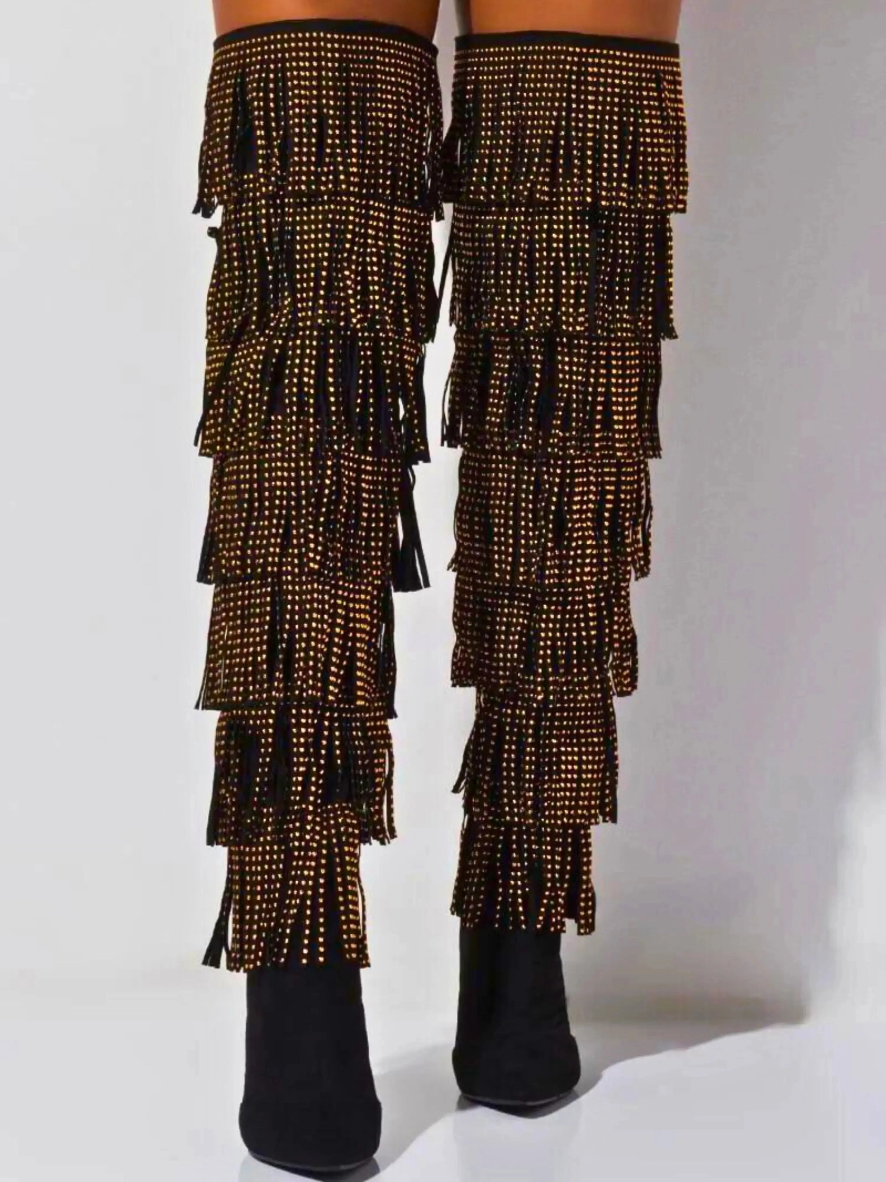 Back view of The Fringe Thigh High Boots by Azalea Wang showcasing layered fringe and gold studs for a dramatic, high-fashion footwear look.