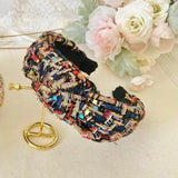 Colorful tweed headband with intricate patterns and knotted design, perfect for gowns