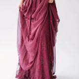 Detail view of The Scarlet Red Scorned Lovers Gown showing the layered chiffon skirt lifted to reveal floral lace beneath.