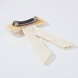 Cream-colored ribbon bow on The Pearl Bow Hair Barrette for elegant hair styling.
