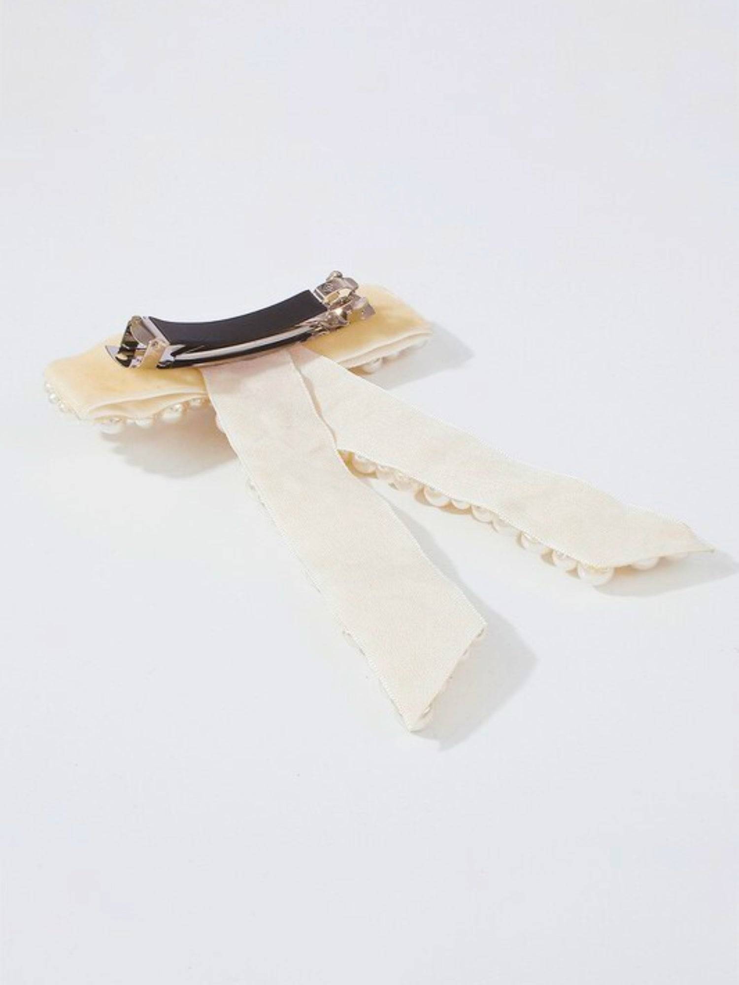 Cream-colored ribbon bow on The Pearl Bow Hair Barrette for elegant hair styling.