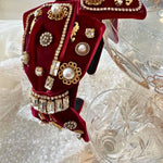 The Little Bit of Blair Red Velvet Headband is crafted with red velvet, crystal gems, and gold-toned embellishments for a luxe finish.