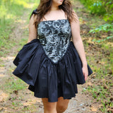 Woman in Rhiannon Corset Dress walking along a scenic path in a forest. A perfect fairytale setting.