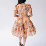 Back view of Ode To Jove Grace Day Dress showing tiered skirt and fitted waist in soft fresco print. Elegant and flattering from every angle.