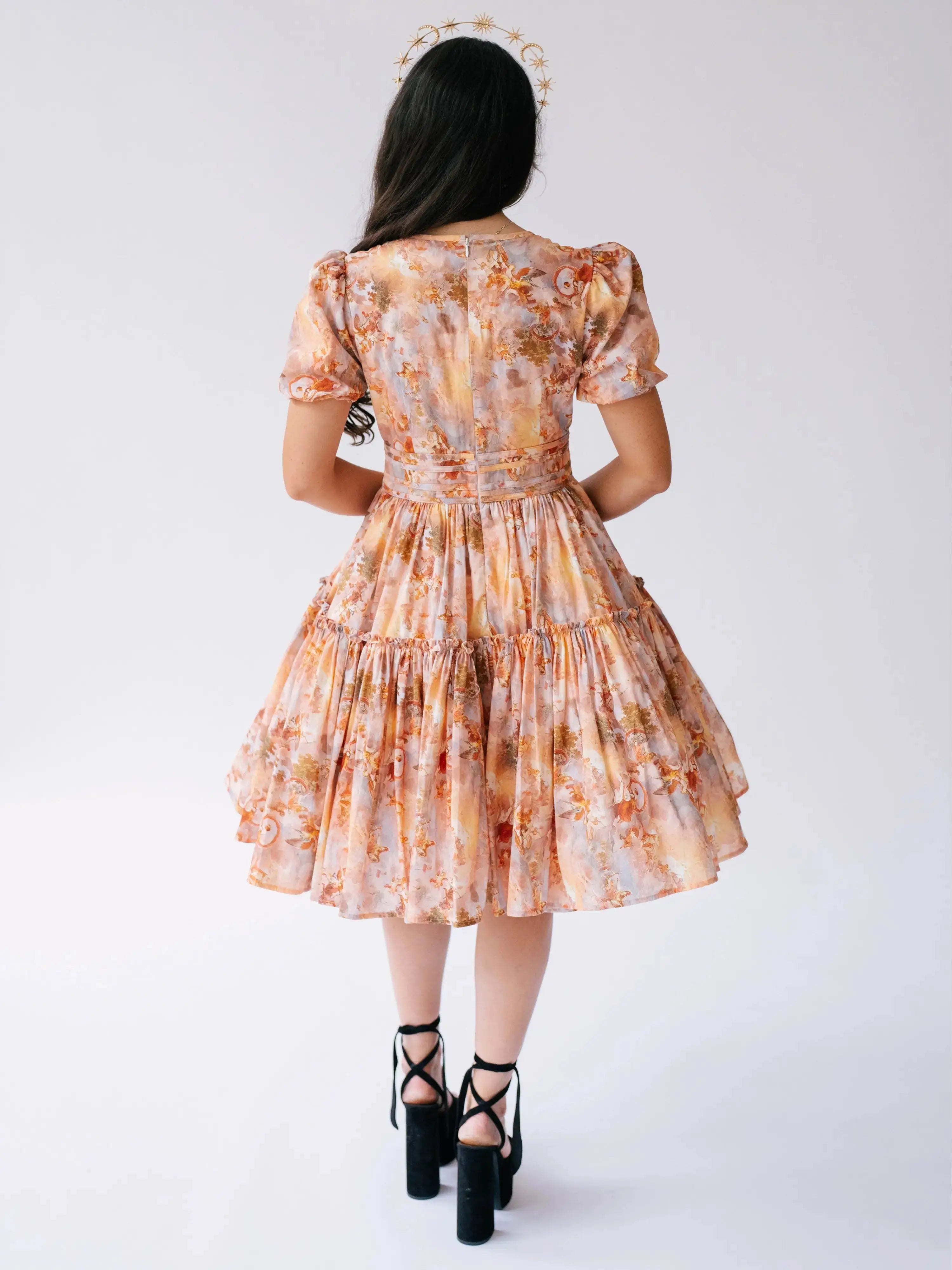Back view of Ode To Jove Grace Day Dress showing tiered skirt and fitted waist in soft fresco print. Elegant and flattering from every angle.
