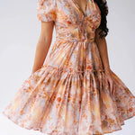 Close-up of Ode To Jove Grace Day Dress showing detailed fresco print, ruched bodice, and swishable tiered skirt. Feminine and structured design.