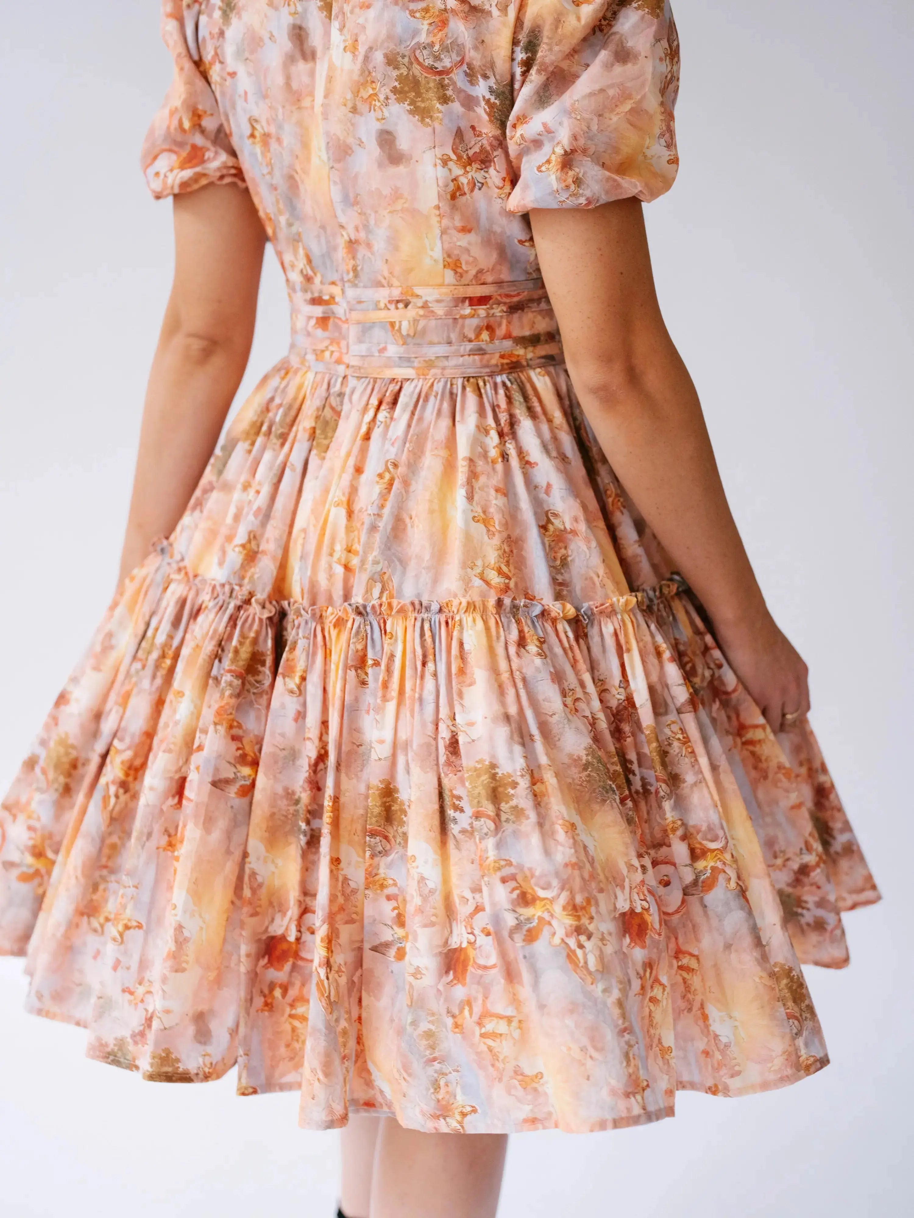 Detail of Ode To Jove Grace Day Dress back skirt with gathered tiers and structured waist. Showcases craftsmanship and romantic print.