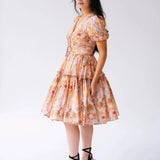 Side view of Ode To Jove Grace Day Dress with puff sleeves and tiered mini skirt in a romantic fresco print. Designed for graceful movement.