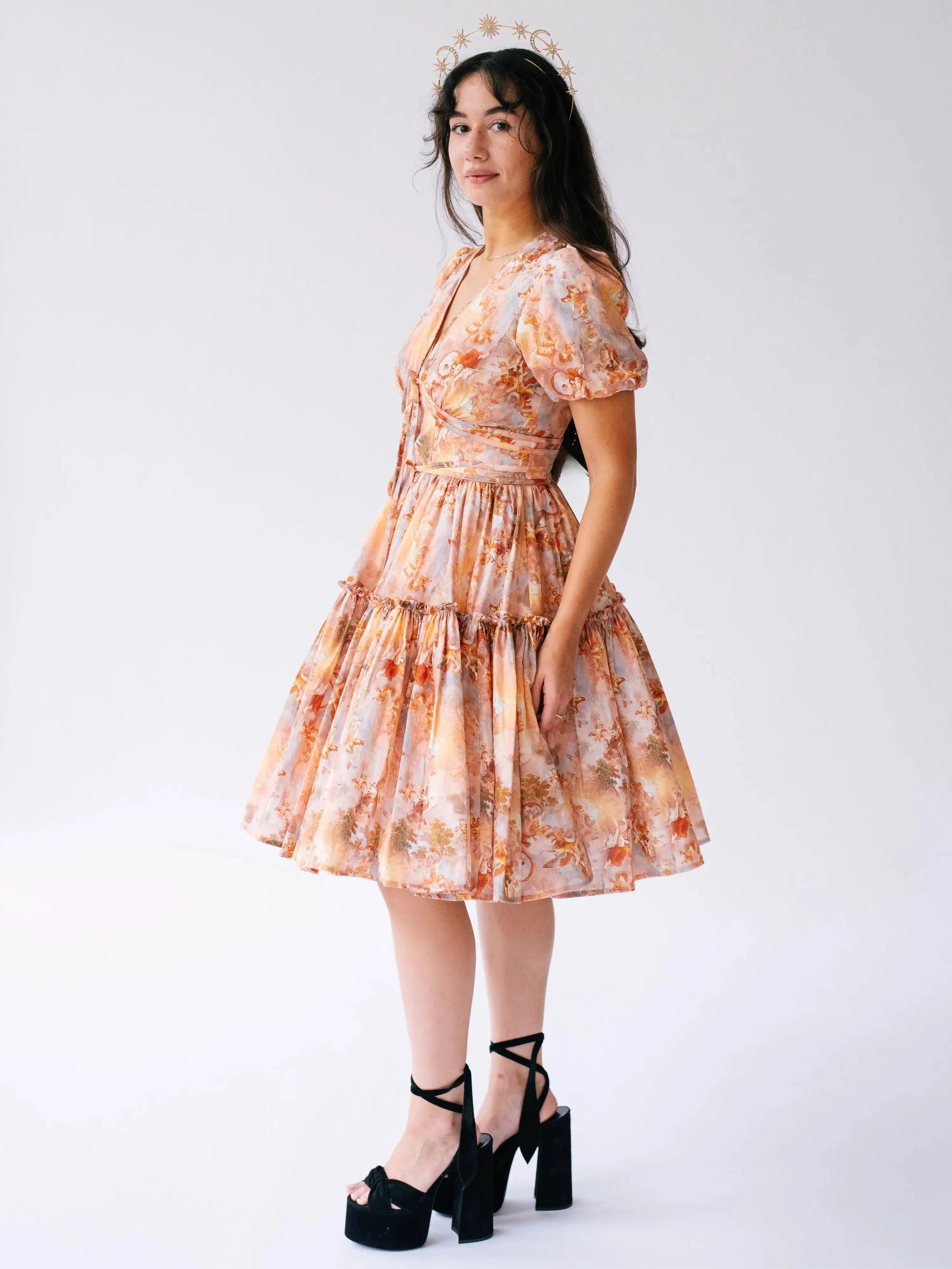 Side view of Ode To Jove Grace Day Dress with puff sleeves and tiered mini skirt in a romantic fresco print. Designed for graceful movement.