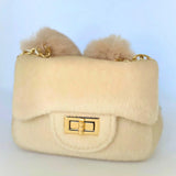 Ivory The Petit Agneau Tiny Purse with gold chain strap and faux fur texture, combining elegance and compact design in a micro handbag.