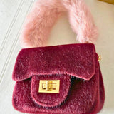 Micro-sized The Petit Agneau Tiny Purse in wine with soft faux fur handle and gold hardware, ideal for stylish minimal accessories.