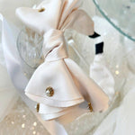 Delicate white bow headband with jewels ideal for a gown or grand bow sash styling.
