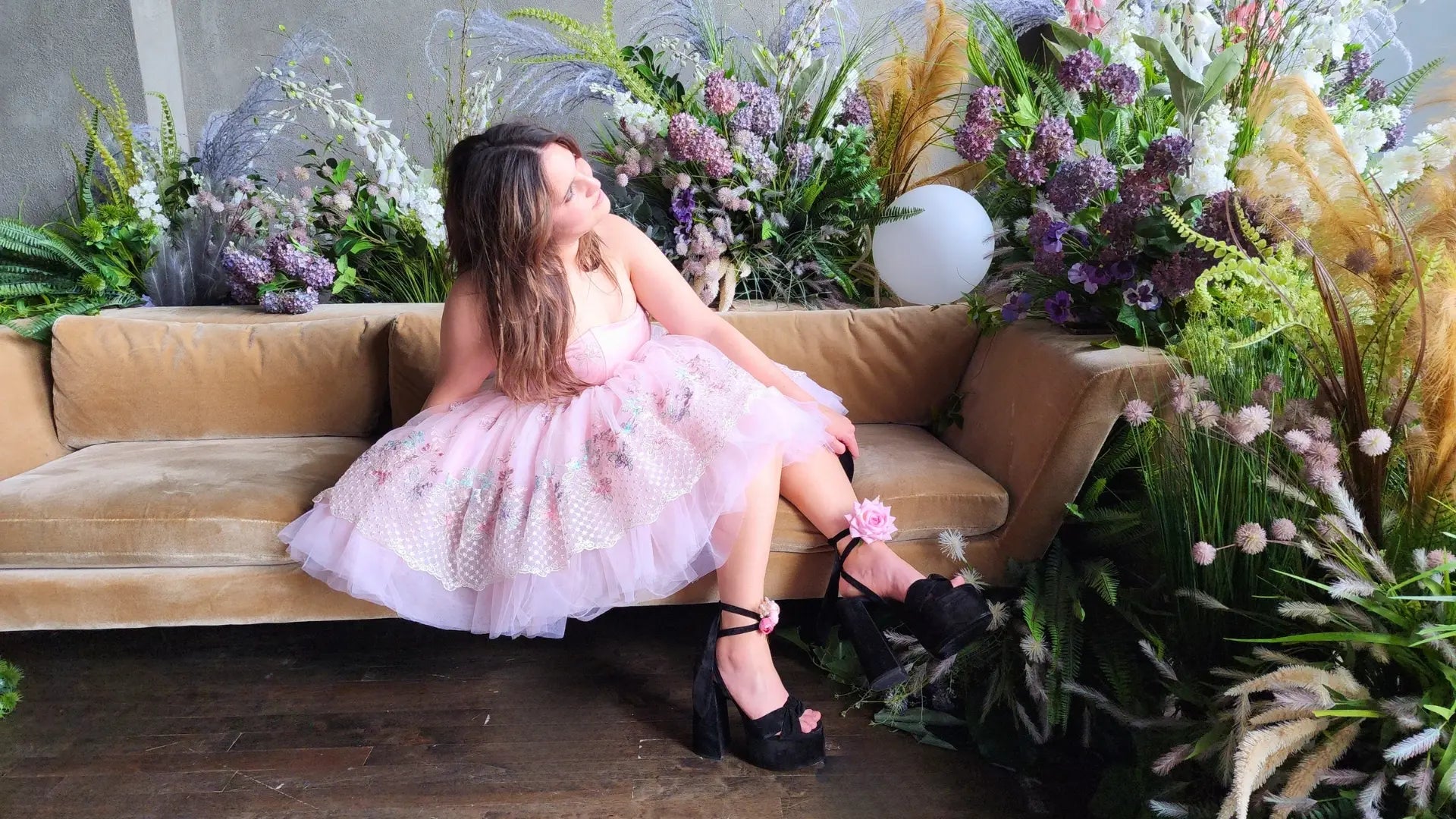 Person in a Pink Tulle Dress on Couch, Inspired by Fashion Week and Alexander McQueen.