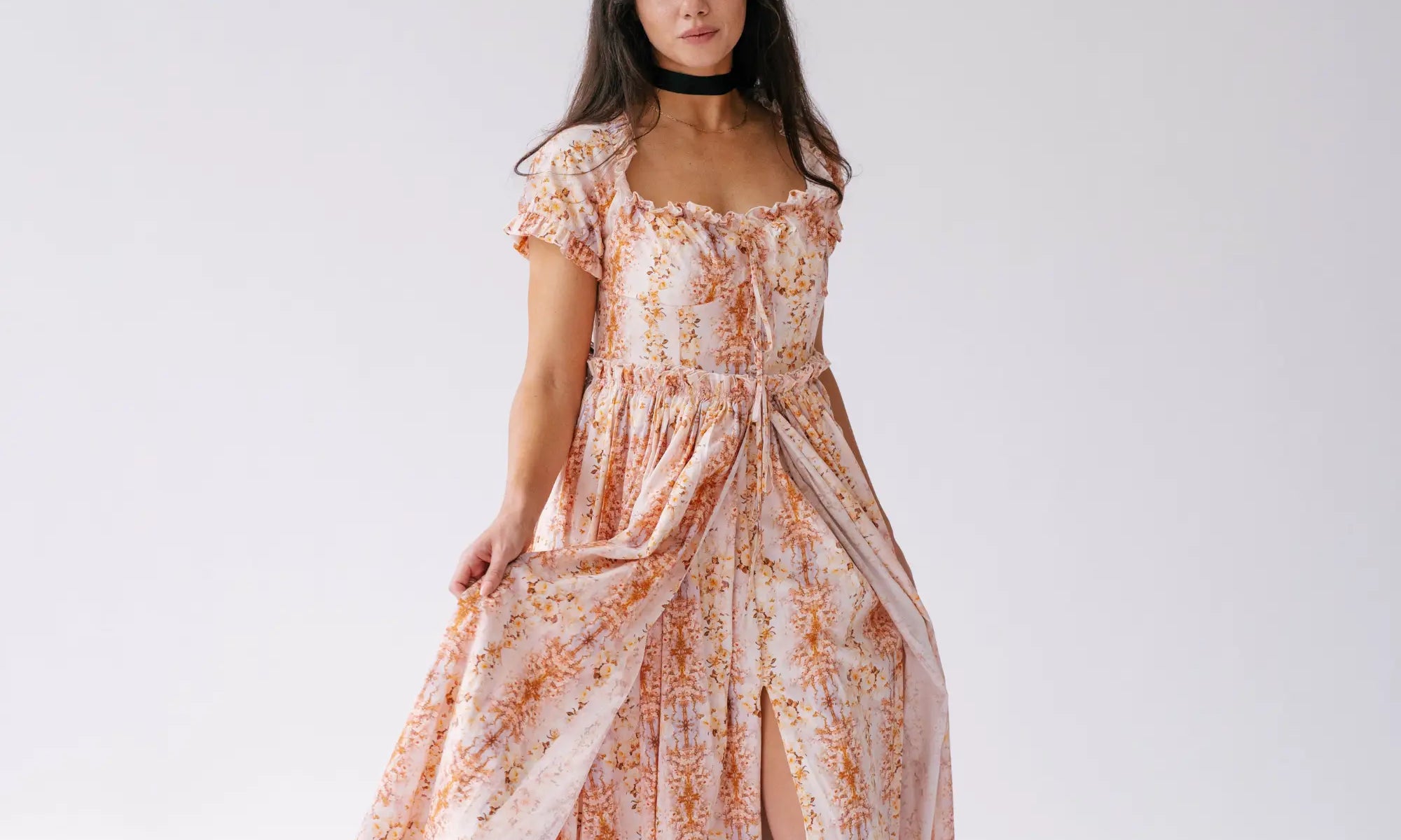 A woman wearing Ivory Sheep's Cotton Twilight Bloom Meadow Gown with natural hair and makeup for a confident look.