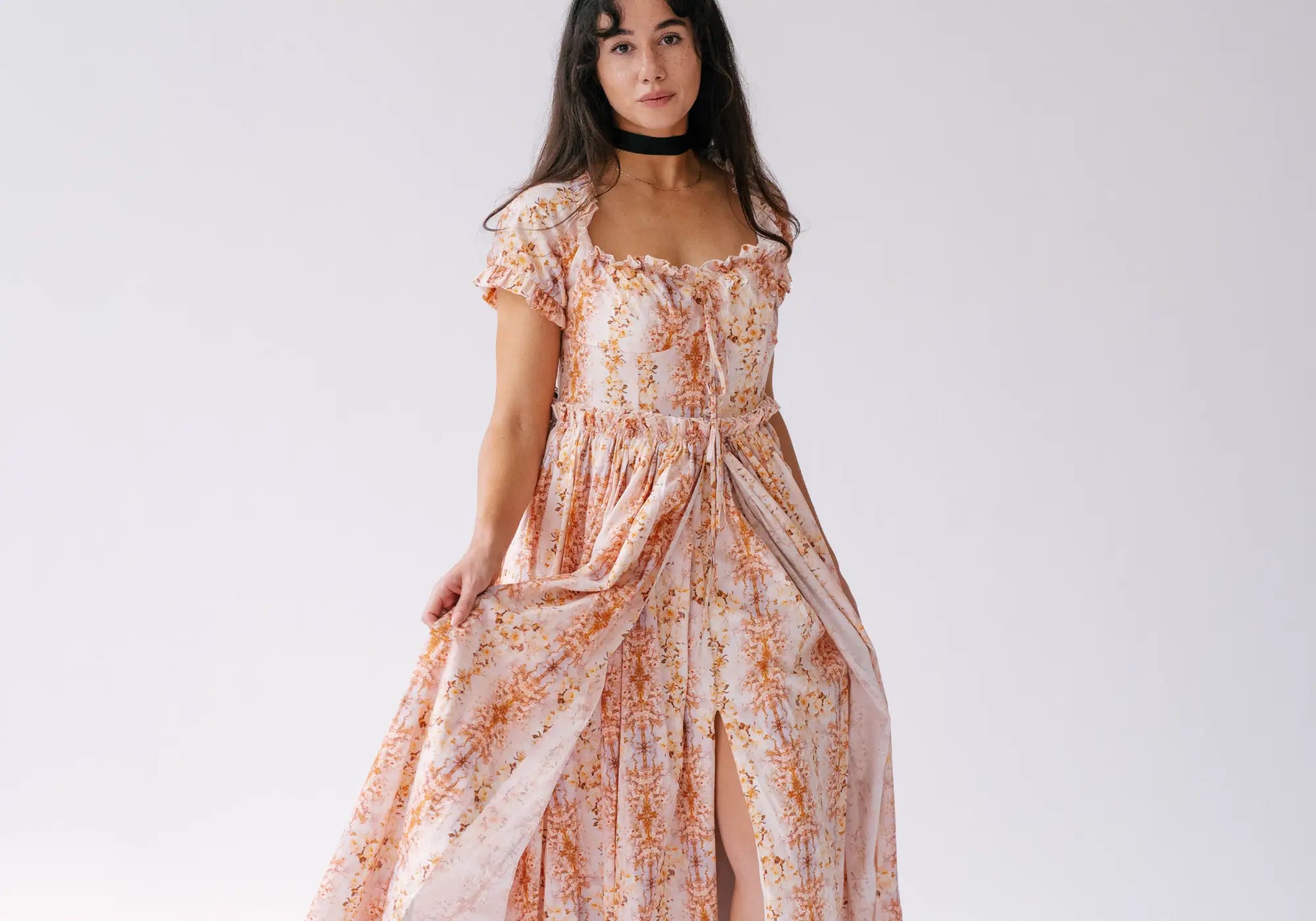 A woman wearing Ivory Sheep's Cotton Twilight Bloom Meadow Gown with natural hair and makeup for a confident look.