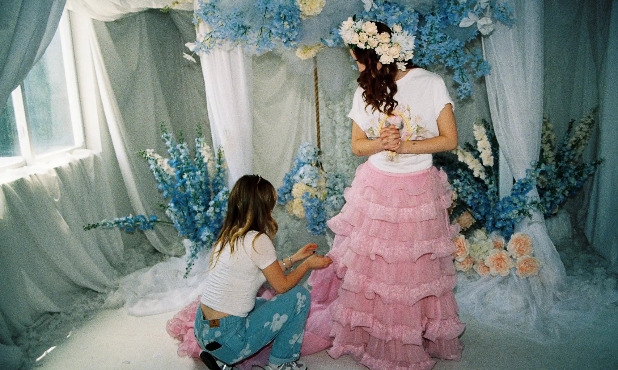 Two women in a dreamy floral setting showcasing slow fashion women's clothing.