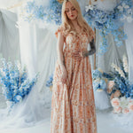 Twilight Bloom Meadow Gown styled in floral set with soft lighting, showcasing dreamy cotton fabric and puff sleeves.