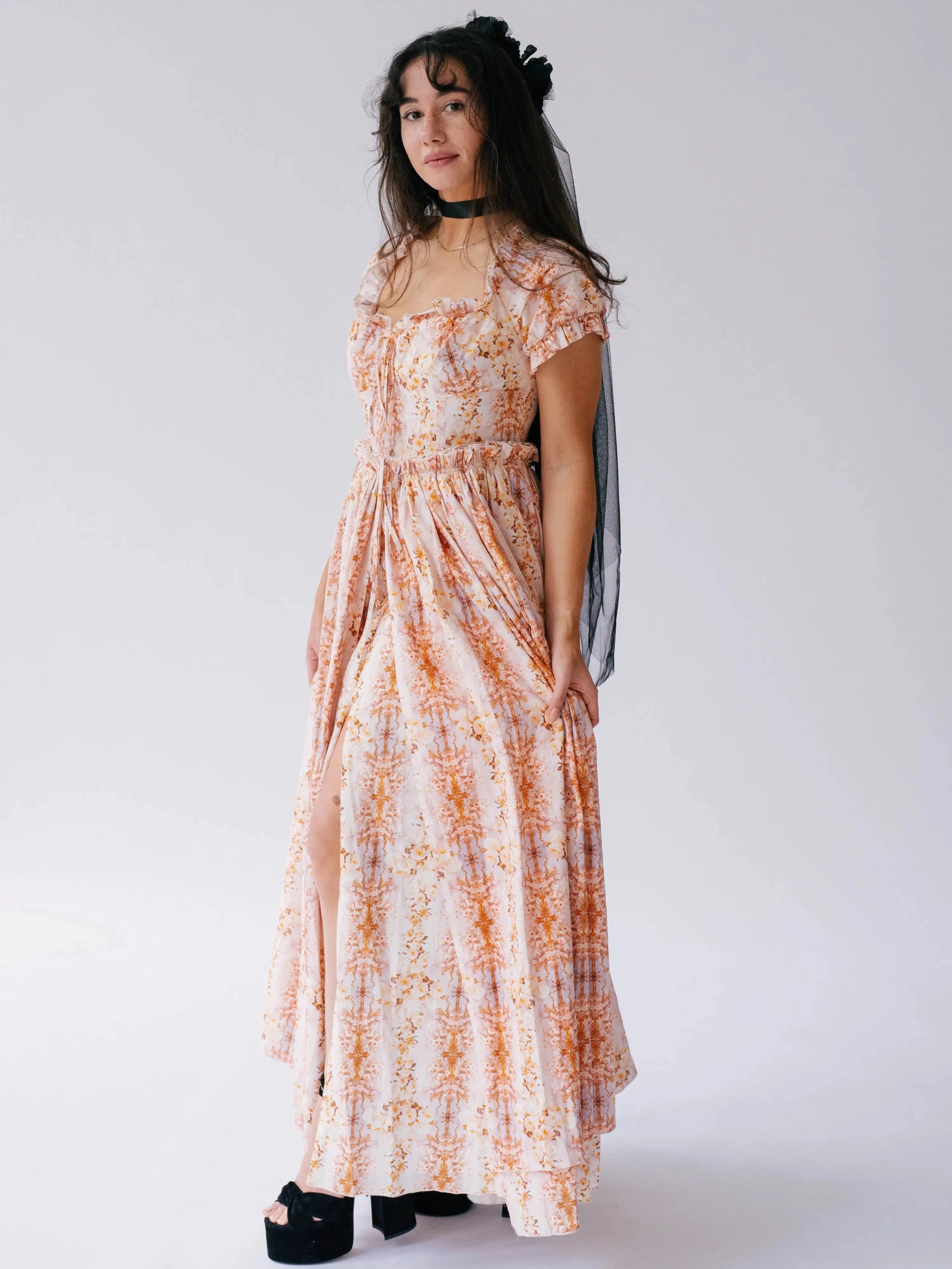 Twilight Bloom Meadow Gown styled with black veil and platform heels, showcasing romantic layered silhouette.