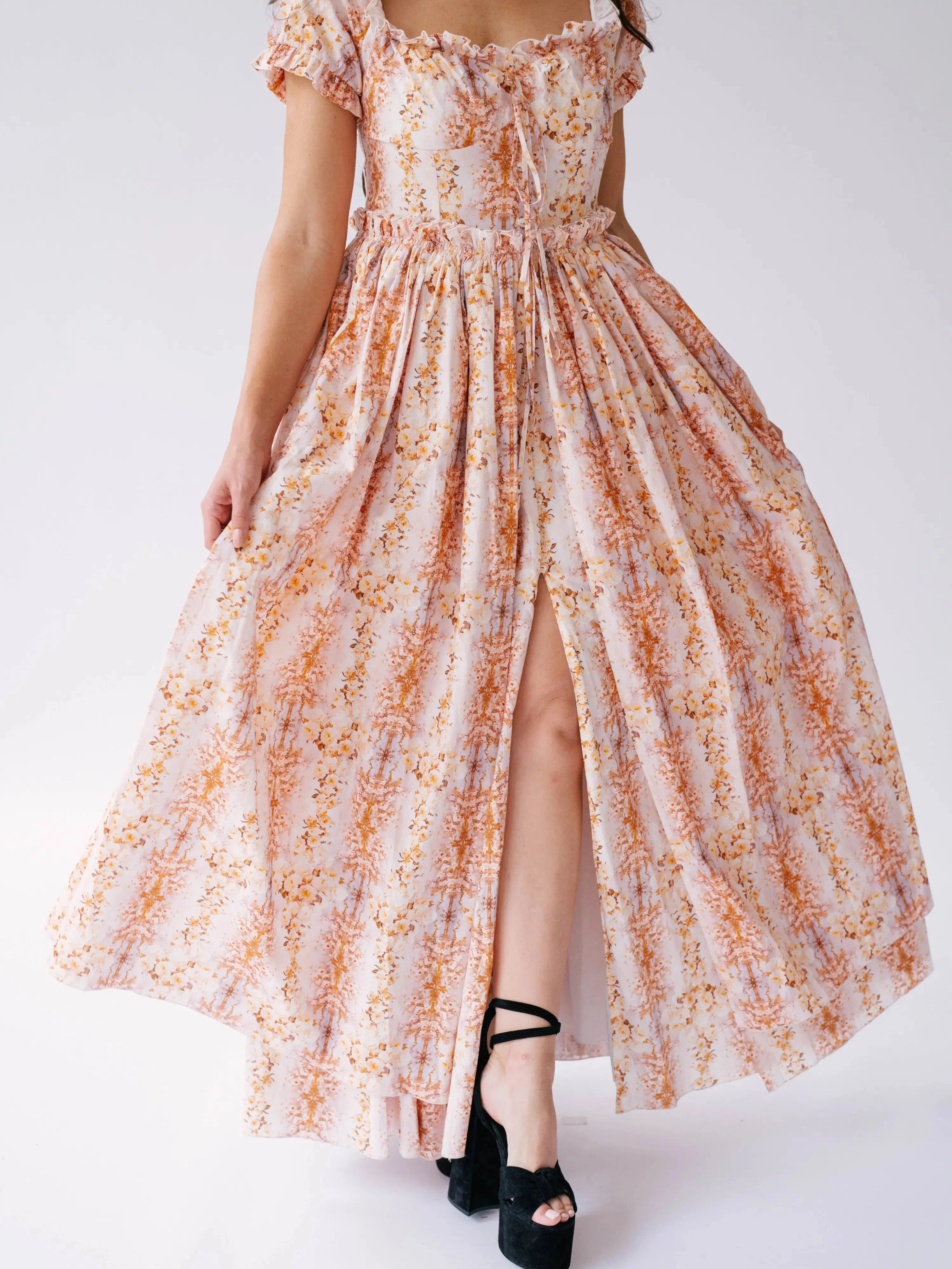Detail of Twilight Bloom Meadow Gown's front slit and floral print, highlighting movement and texture of the skirt.