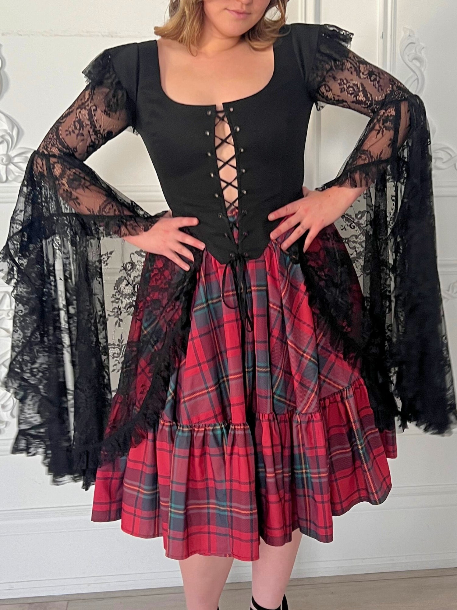 The Guinevere's Revenge Corset Top - Guinevere's revenge made in the rich black hue exudes timeless allure, while the corset's structured design ensures a flattering fit, cinching at the waist to accentuate your curves. The luxurious theatrical lace sleev