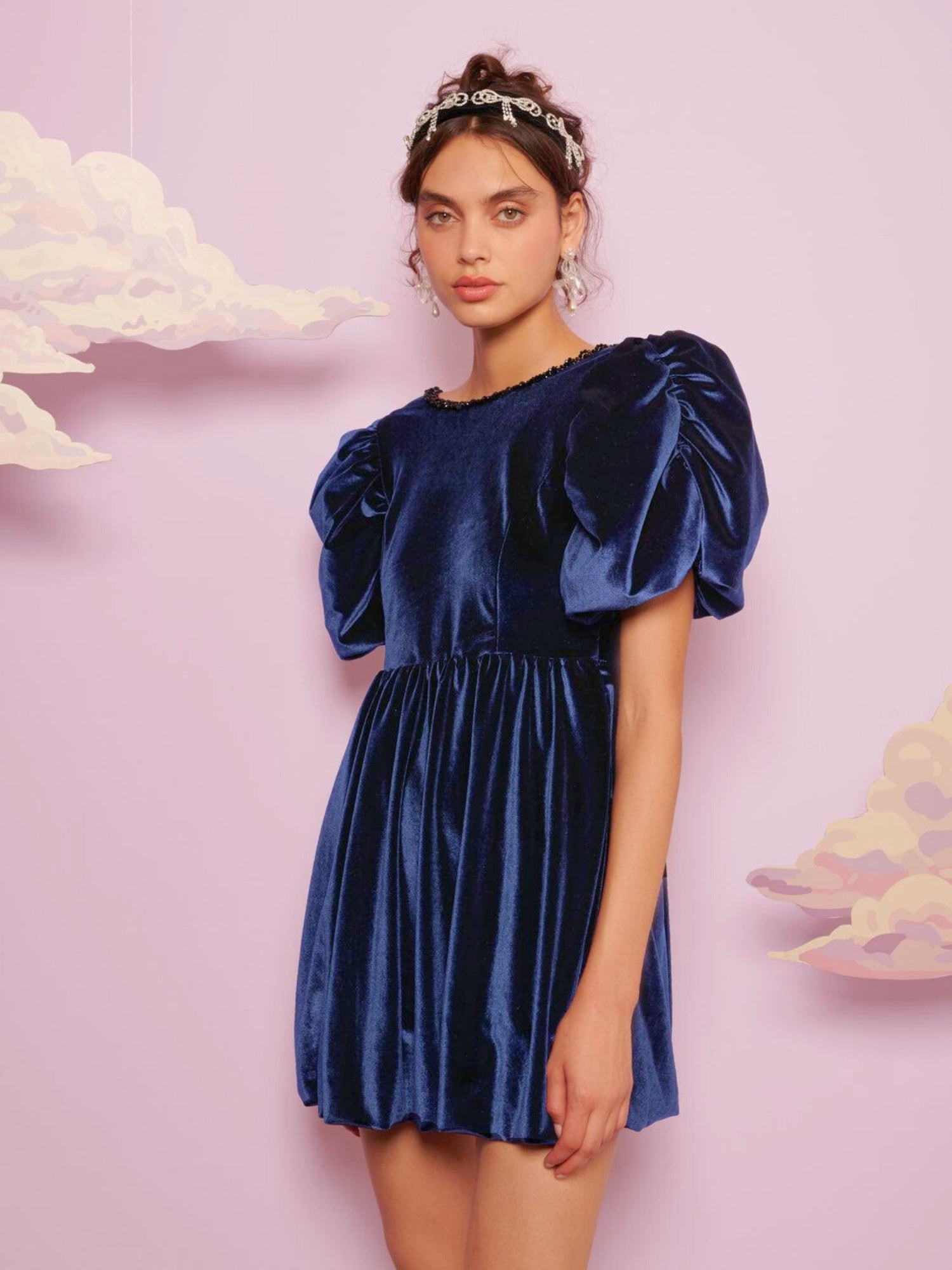 Spell Velvet Mini Dress - The Spell Velvet mini dress by SisterJane is the ultimate holiday dress! The softest blue velvet piece, with a deep V back neckline framed with black pearls, and puff sleeves. This piece features a bubble hem and is lined with a