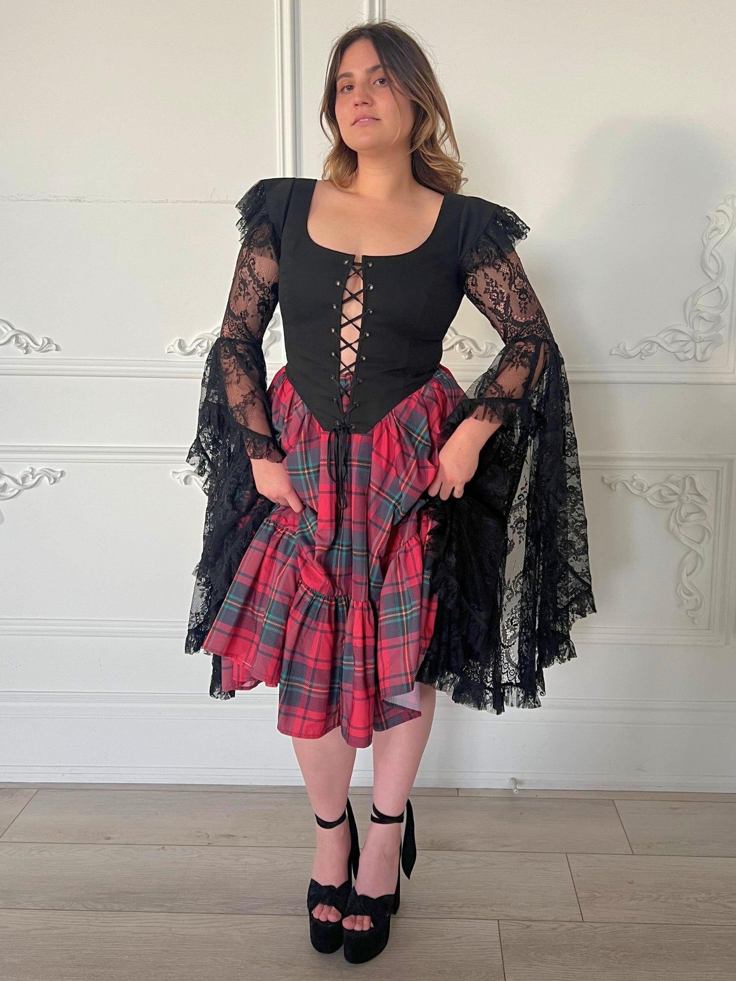The Guinevere's Revenge Corset Top - Guinevere's revenge made in the rich black hue exudes timeless allure, while the corset's structured design ensures a flattering fit, cinching at the waist to accentuate your curves. The luxurious theatrical lace sleev