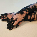 The Opera Gloves - These hand sewn Opera Gloves were made for the fashion lover! Made of a poly based tulle, with hand sewn lace appliques this is a glove your closet needs! Ability to extend the glove to the upper arm. Scalloped lace trim. Fit Note: This