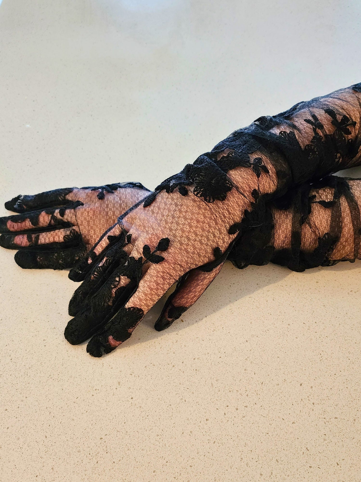 The Opera Gloves - These hand sewn Opera Gloves were made for the fashion lover! Made of a poly based tulle, with hand sewn lace appliques this is a glove your closet needs! Ability to extend the glove to the upper arm. Scalloped lace trim. Fit Note: This
