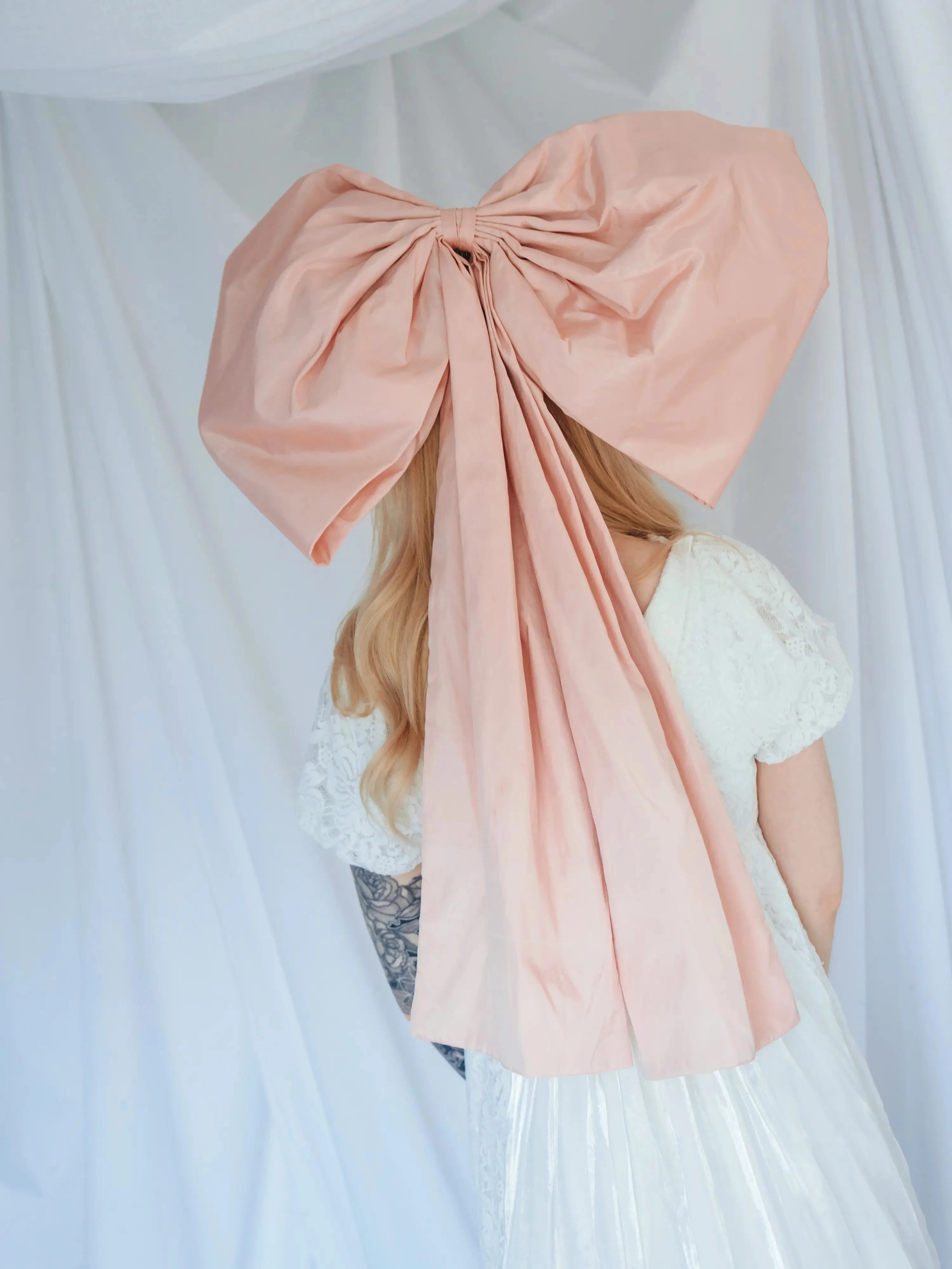 Back view of Baby Antoinette Pink Hair Bow showing its 25-inch length and structured silk taffeta design in soft pink.