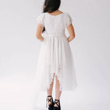 Back view of Belladonna Lace Dress showing lace bodice, flutter sleeves, and long tulle train cascading from high-low hem.