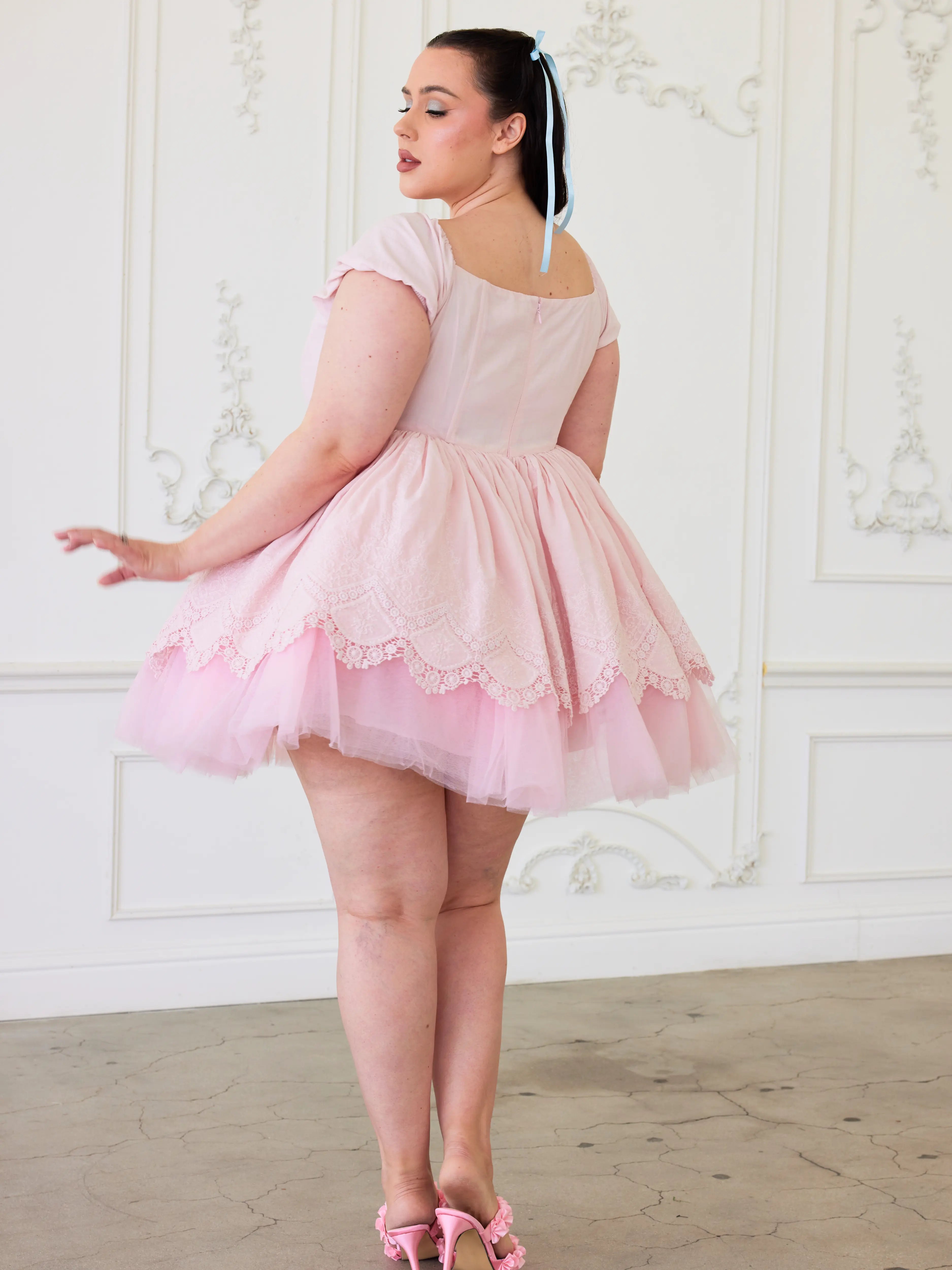 A pink lace party dress with short sleeves and tulle skirt to create a dreamy puff dress.