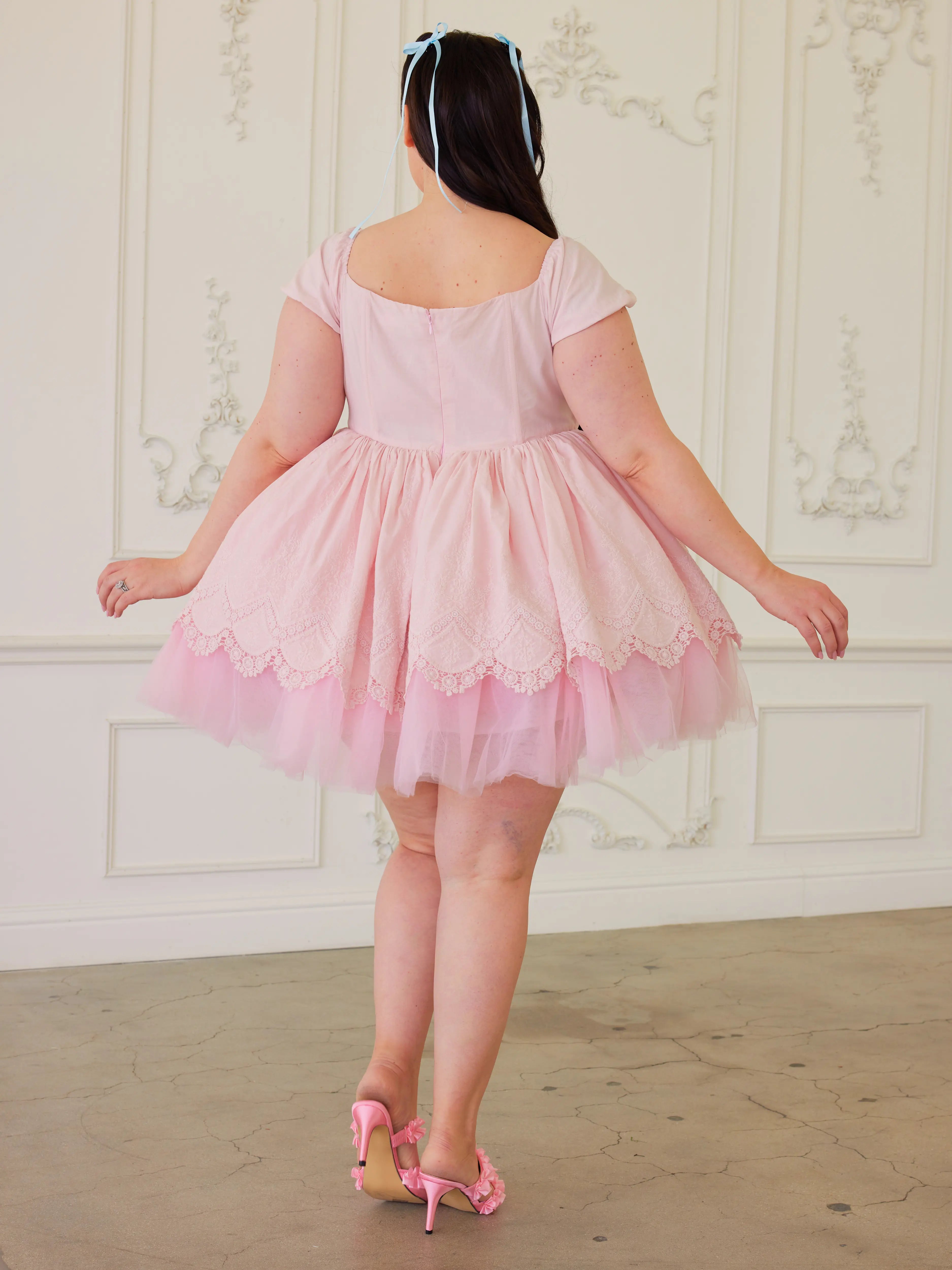 Tulle soft pink party dress with cap sleeves and a flared skirt.