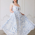 A flowing corset gown in white polyester chiffon fabric with delicate blue floral toile patterns.