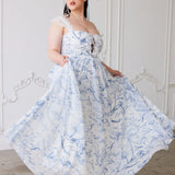 A flowing corset gown in white polyester chiffon fabric with delicate blue floral toile patterns.