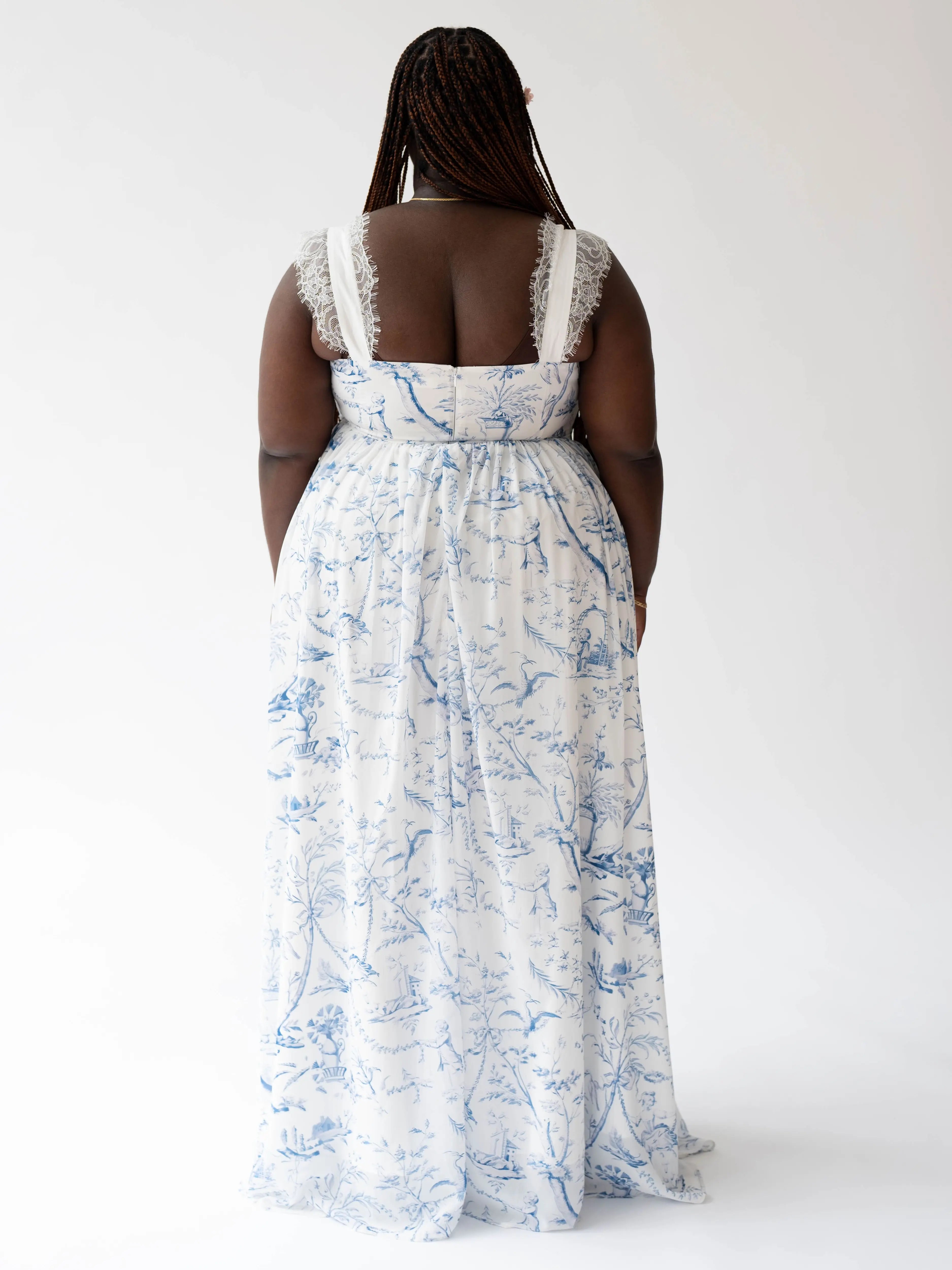 White and blue floral print maxi dress with lace straps viewed from behind.