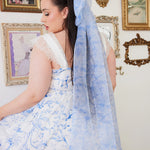 an extra large hair bow with a light blue toile print. Paired with the Blue Toile Angel Dress