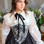 Woman in Victorian-style  corset gown underneath the Ciela Snow White Shrug with lace trim and bow tie