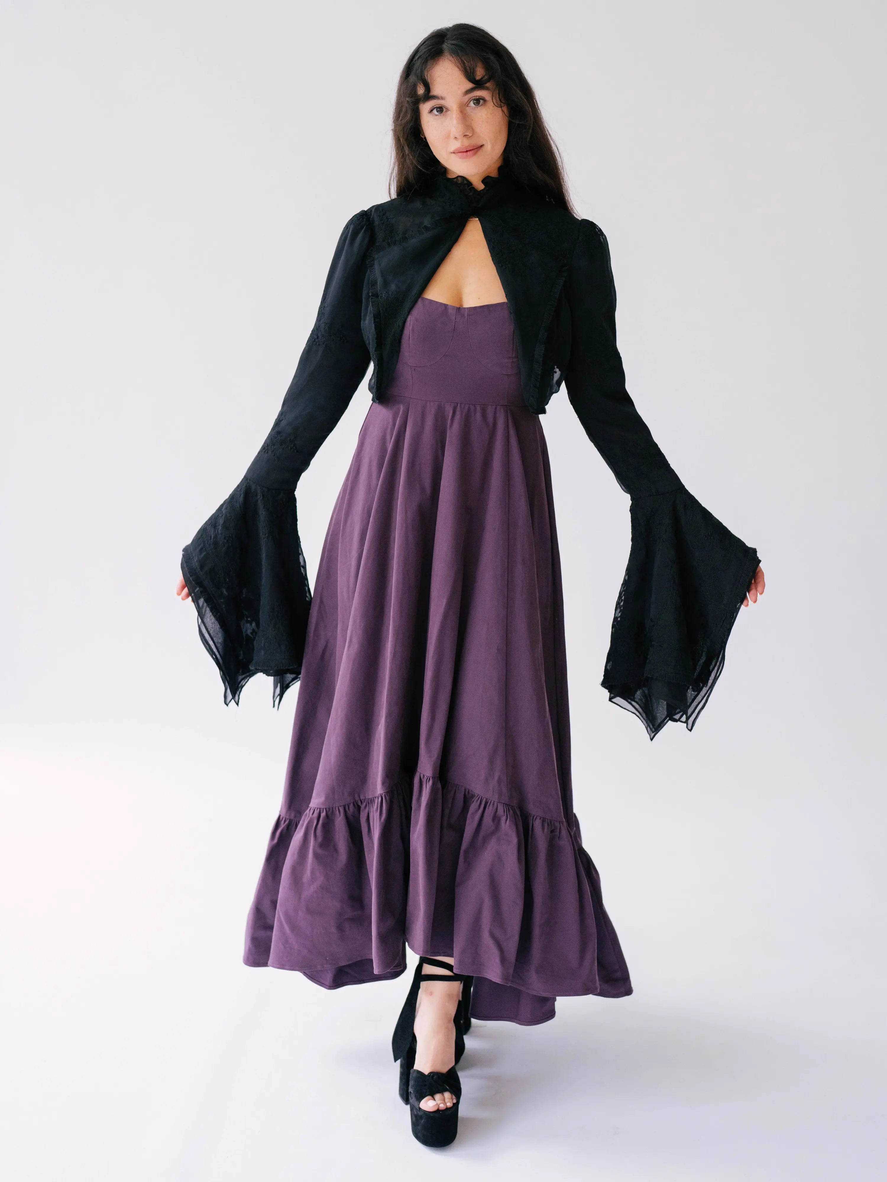 Black lace bolero jacket over top a heavy cotton purple midi dress.