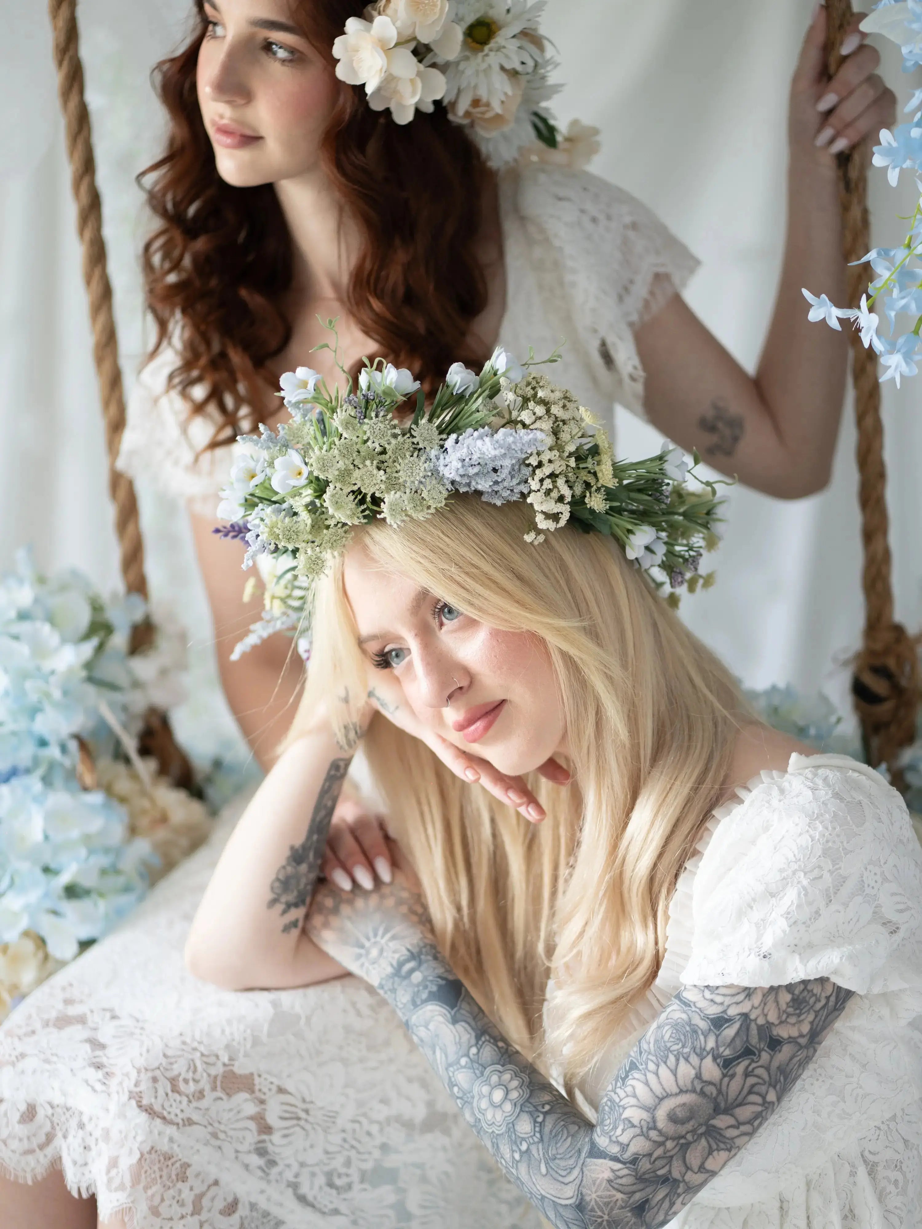 Romantic Dauphine Lace Gown worn with floral crown, showcasing lace detail and soft sleeves, perfect for weddings or garden parties.