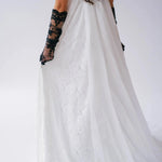 Back detail of Dauphine Lace Gown with sheer train and lace overlay, styled with black gloves for a bold bridal statement.