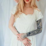 Close-up of Dauphine Lace Gown's bodice and ruffled neckline, showcasing delicate lace and soft bridal elegance.