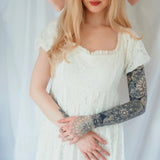 Close-up of Dauphine Lace Gown's bodice and ruffled neckline, showcasing delicate lace and soft bridal elegance.