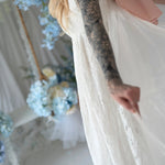 Close-up of Dauphine Lace Gown's lace texture and flowing fabric, highlighting the gown's dreamy and ethereal bridal design.