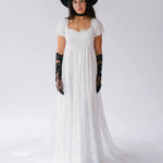 Front view of Dauphine Lace Gown featuring square neckline and puff sleeves, styled with black hat and gloves for bridal elegance.