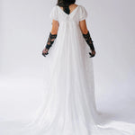 Back view of Dauphine Lace Gown with long train and empire waist, styled with black accessories for a unique wedding dress look.